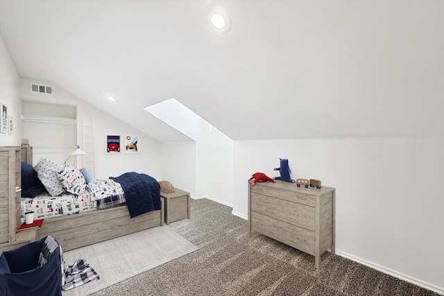 carpeted bedroom featuring vaulted ceiling with skylight