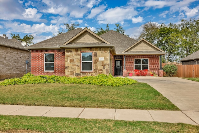 craftsman inspired home with a front lawn