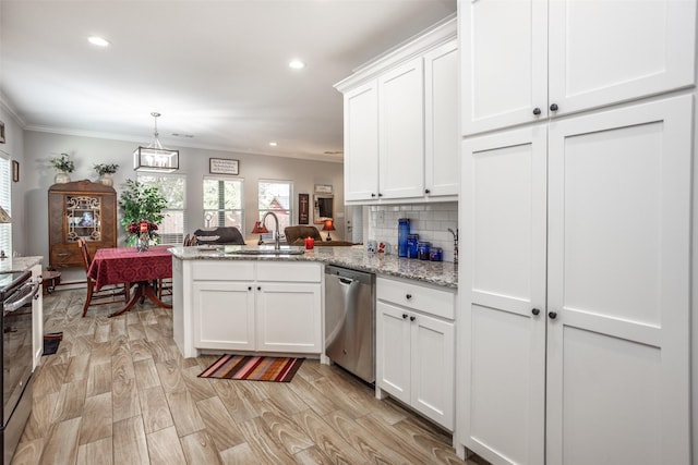 kitchen with sink, white cabinetry, stainless steel appliances, light stone countertops, and kitchen peninsula