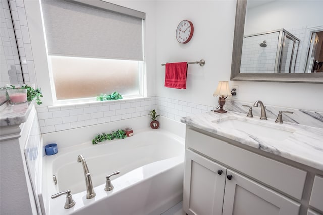 bathroom featuring vanity and shower with separate bathtub