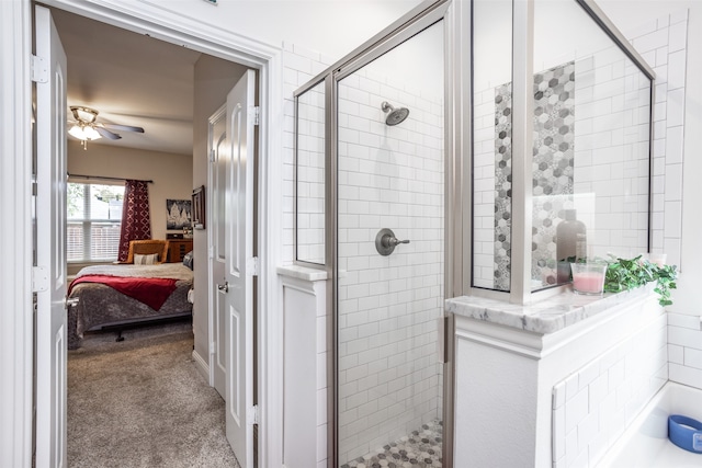 bathroom featuring ceiling fan and an enclosed shower