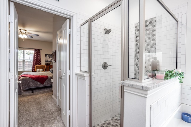 bathroom featuring a shower with door and ceiling fan