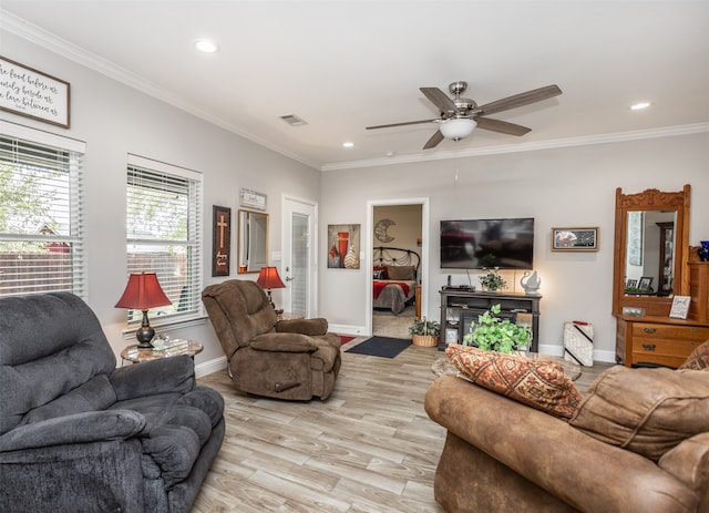 living room with ornamental molding, light wood-type flooring, and ceiling fan