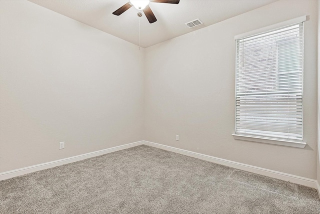 carpeted spare room with ceiling fan