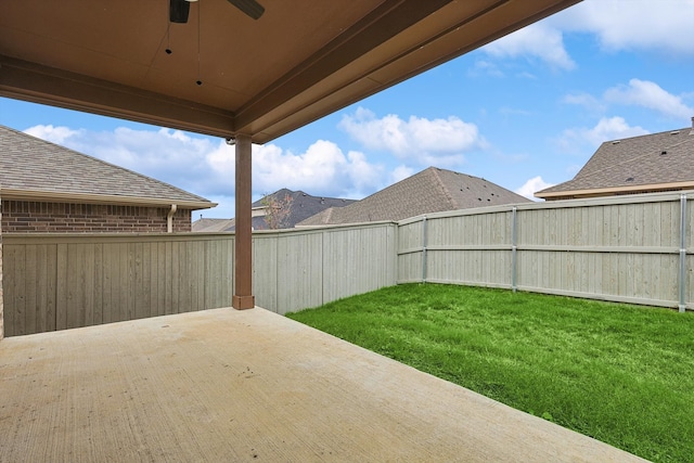 view of yard with ceiling fan and a patio