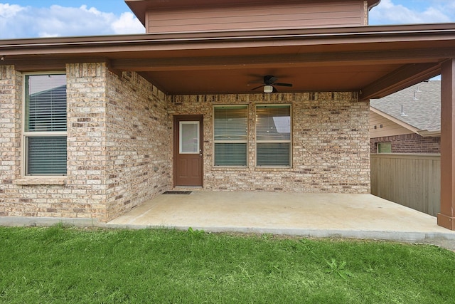 entrance to property featuring a patio area and ceiling fan