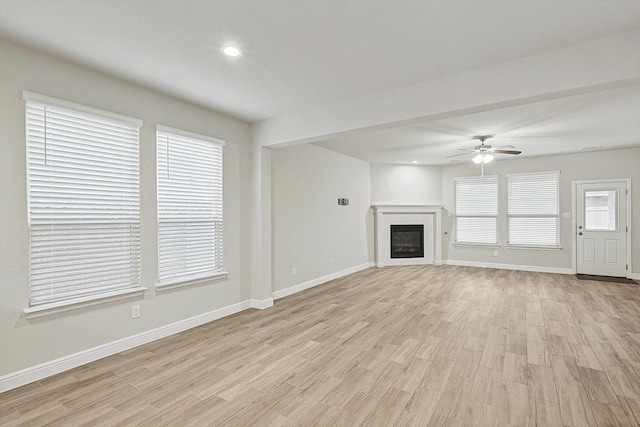 unfurnished living room with light hardwood / wood-style flooring and ceiling fan