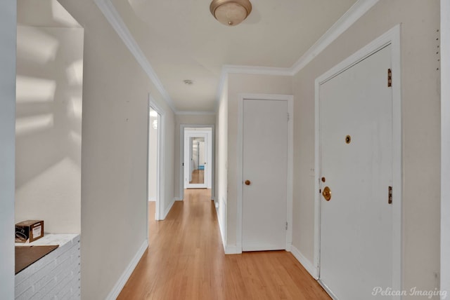 corridor featuring light wood-type flooring and ornamental molding