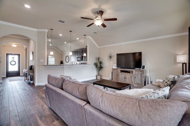 living room with ceiling fan, crown molding, dark wood-type flooring, and vaulted ceiling