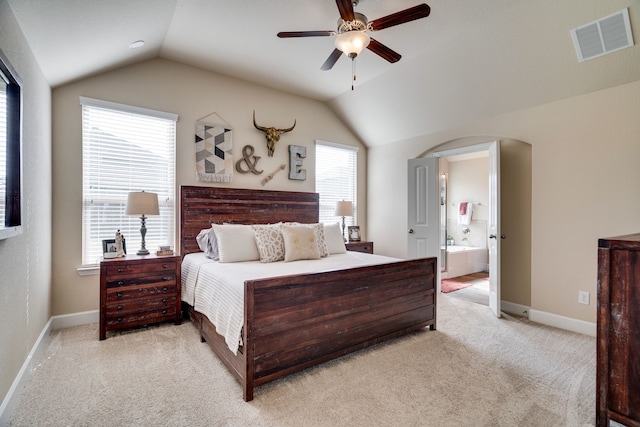 carpeted bedroom featuring ensuite bathroom, ceiling fan, and lofted ceiling