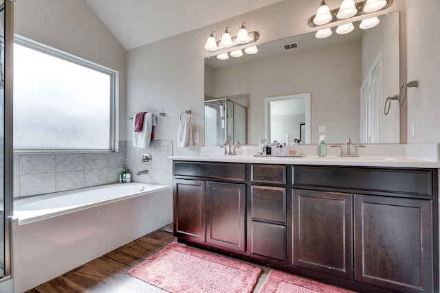 bathroom with vanity, wood-type flooring, and independent shower and bath