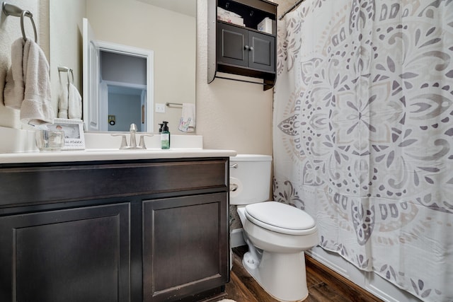 full bathroom with vanity, wood-type flooring, shower / bath combo, and toilet