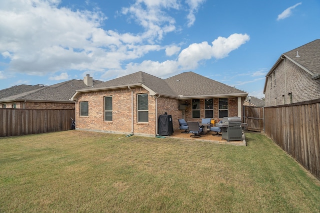 rear view of property with a yard