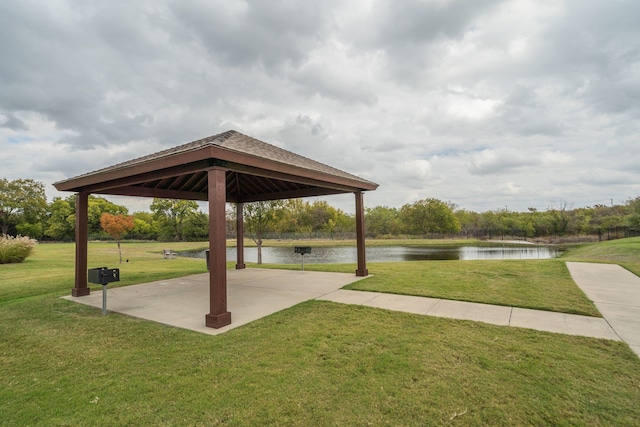 view of home's community featuring a gazebo, a water view, and a lawn