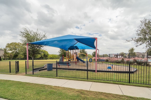 view of jungle gym featuring a lawn