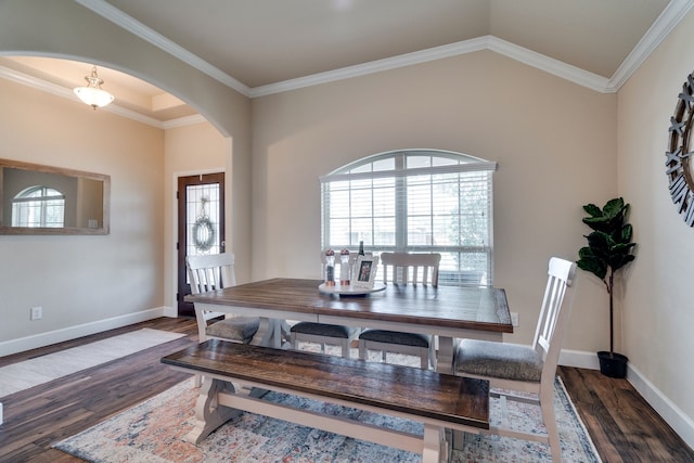 dining room featuring crown molding, dark hardwood / wood-style flooring, and vaulted ceiling