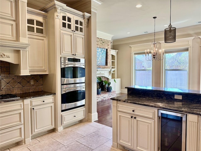 kitchen featuring beverage cooler, cream cabinetry, and stainless steel double oven