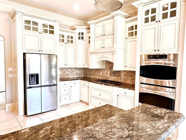 kitchen featuring crown molding, stainless steel appliances, light tile patterned flooring, and decorative backsplash