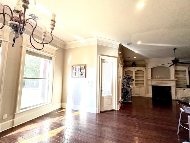 living room featuring baseboards, visible vents, ornamental molding, hardwood / wood-style floors, and a fireplace