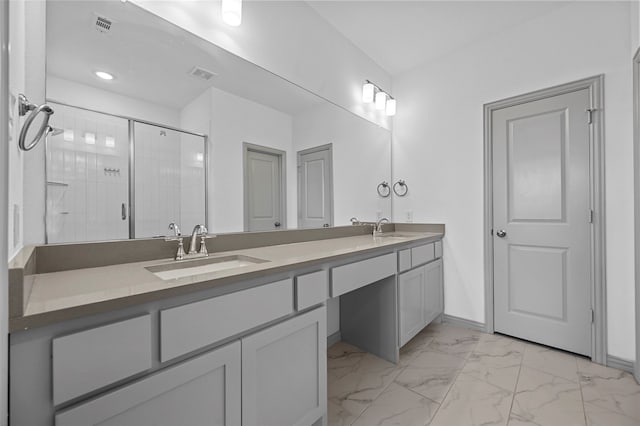 bathroom featuring vanity and an enclosed shower