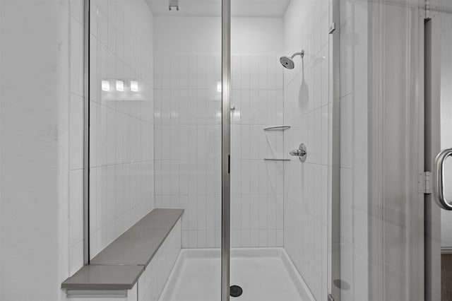 bathroom with a shower with door