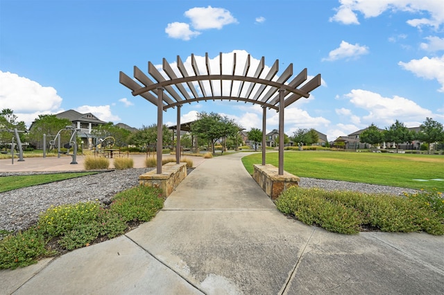 view of community with a yard and a pergola