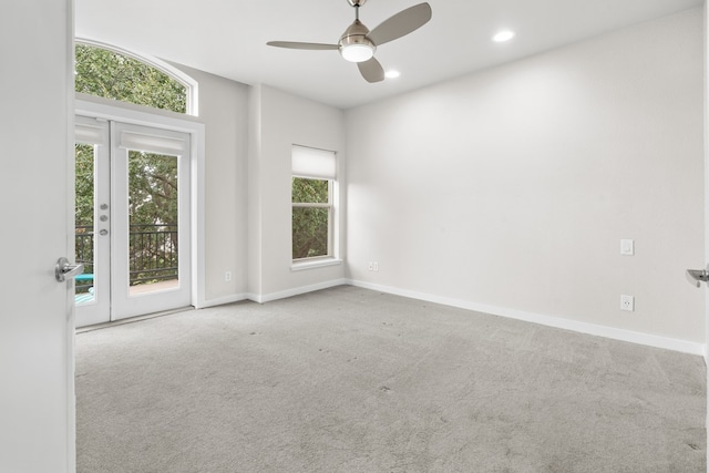 unfurnished room with light carpet and ceiling fan