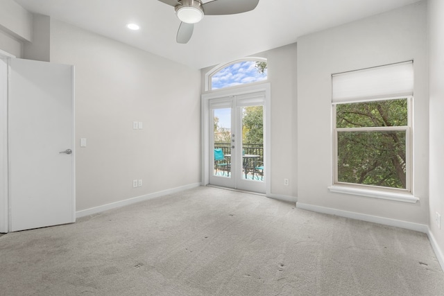 carpeted spare room with french doors and ceiling fan