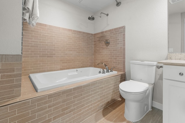 full bathroom featuring vanity, toilet, hardwood / wood-style flooring, and tiled shower / bath combo