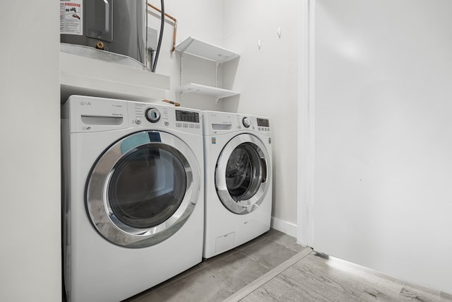 washroom featuring washing machine and dryer and light wood-type flooring