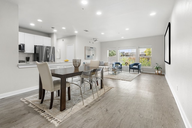 dining space with light hardwood / wood-style flooring