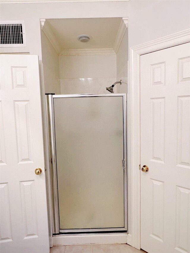 bathroom with ornamental molding, walk in shower, and tile patterned floors