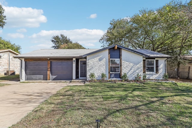 ranch-style house featuring a front yard and a garage