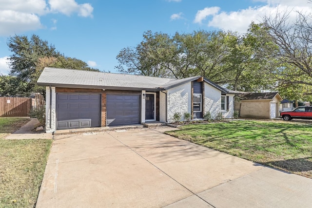 single story home featuring a garage and a front lawn