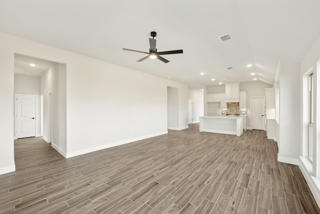 unfurnished living room with light hardwood / wood-style flooring and ceiling fan