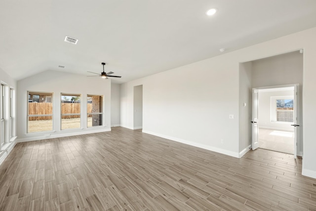 unfurnished living room featuring ceiling fan and vaulted ceiling