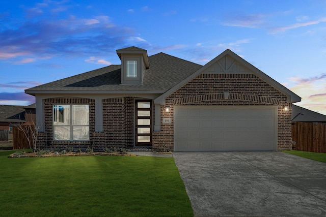 view of front facade featuring a garage and a lawn