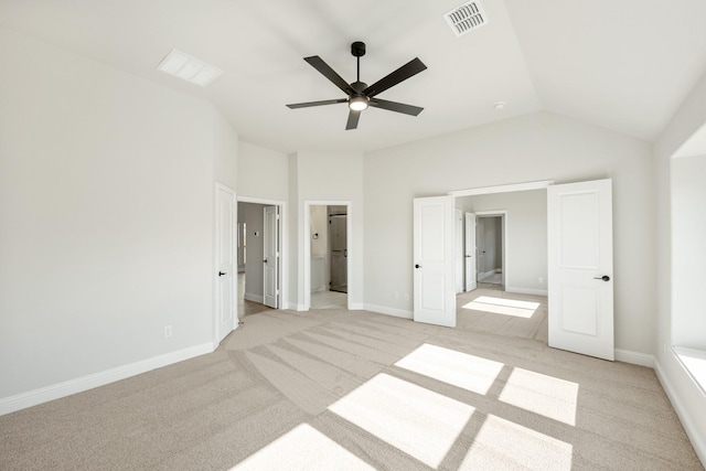 unfurnished bedroom with ceiling fan, high vaulted ceiling, connected bathroom, and light colored carpet