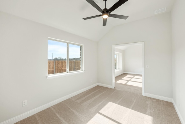 unfurnished room with lofted ceiling, light colored carpet, and ceiling fan