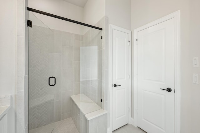 bathroom with walk in shower and tile patterned floors