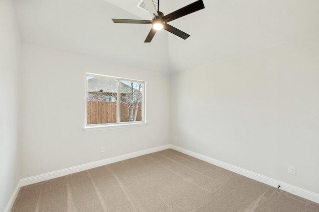 empty room featuring ceiling fan, lofted ceiling, and carpet flooring