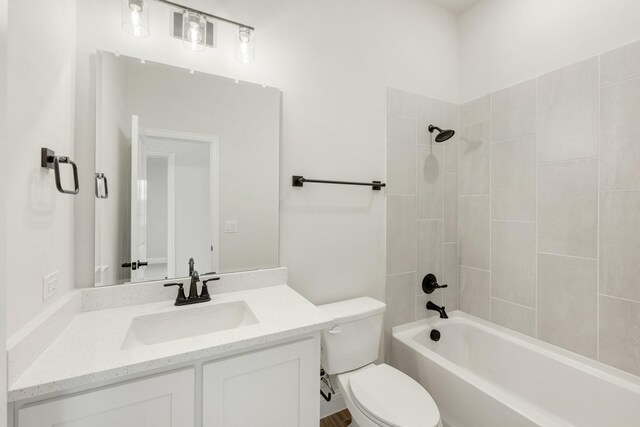 full bathroom with tiled shower / bath combo, vanity, and toilet