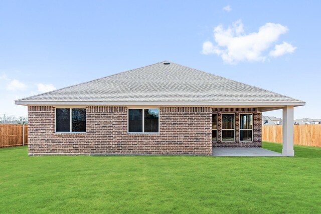 back of property featuring a patio and a yard