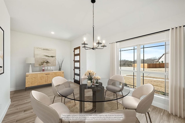 dining room with an inviting chandelier and light hardwood / wood-style floors