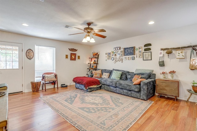 living room with ceiling fan and light wood-type flooring