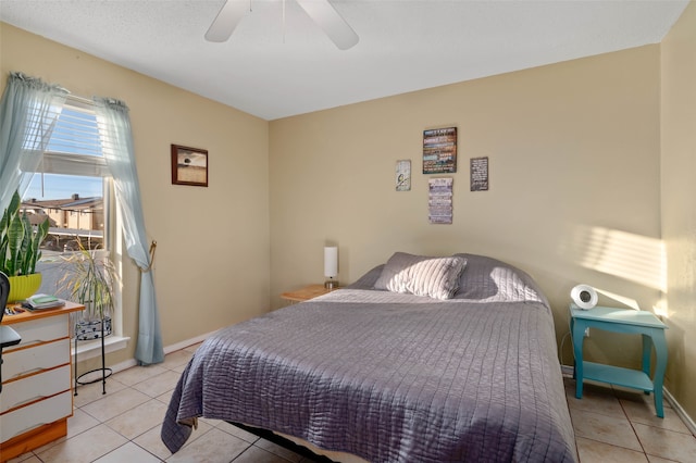 tiled bedroom featuring ceiling fan