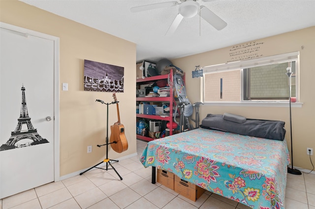 bedroom with a textured ceiling, tile patterned floors, and ceiling fan