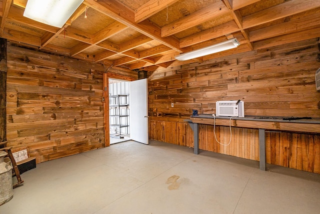 basement with a wall unit AC and wooden walls