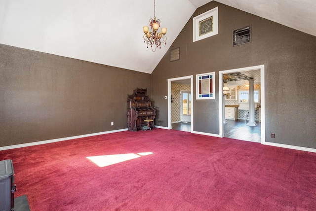 interior space featuring ornate columns, high vaulted ceiling, a chandelier, and dark carpet