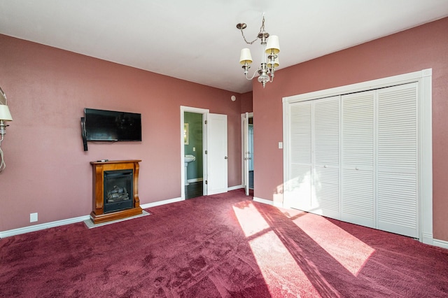 unfurnished bedroom with carpet flooring, a closet, and a chandelier